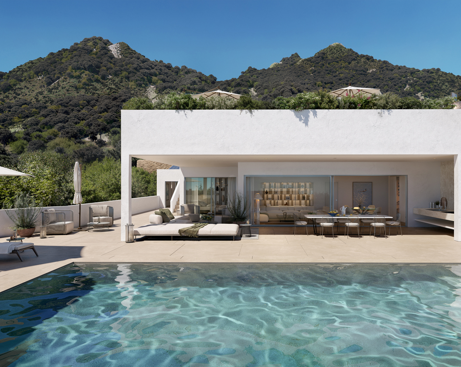 Villa Pintadera - Vista frontale di Villa Pintadera con la piscina, un grande tavolo esterno, lettini e ombrelloni
