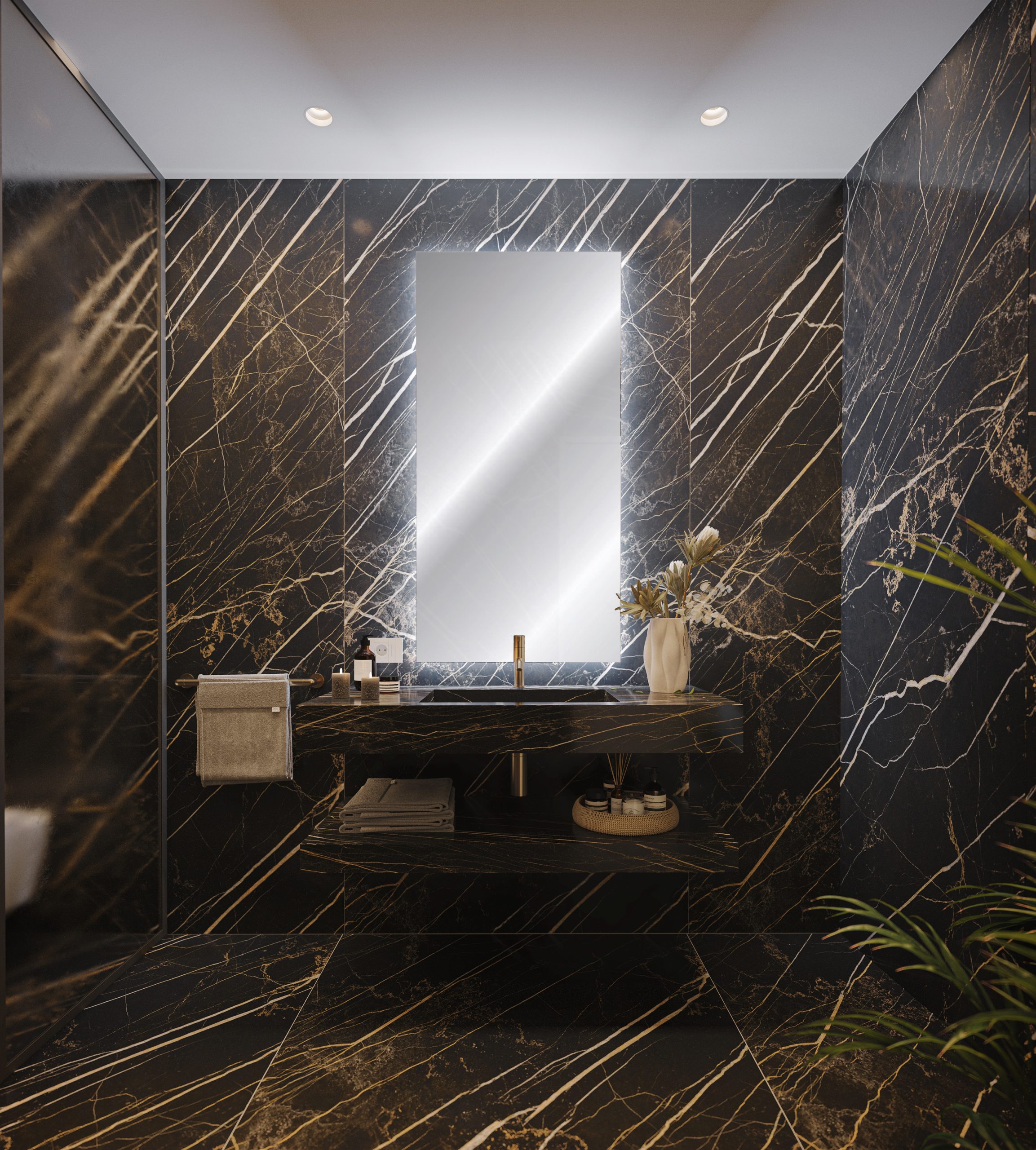Spiga Suites - Vista del bagno rifinito in marmo scuro con lavabo e ampio specchio illuminato