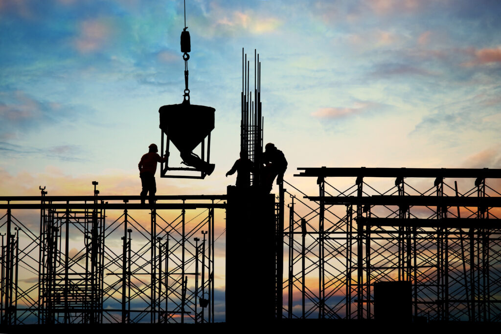 Silhouette of a building under construction with workers